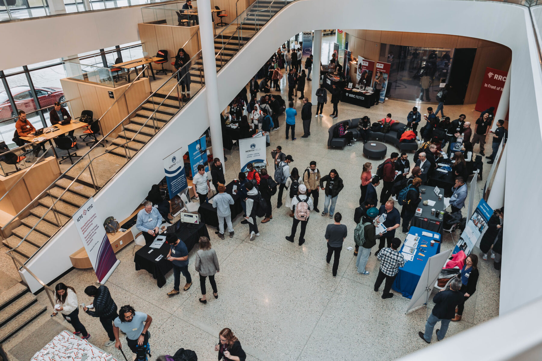 Shot from the second floor of an atrium looking down at people milling around