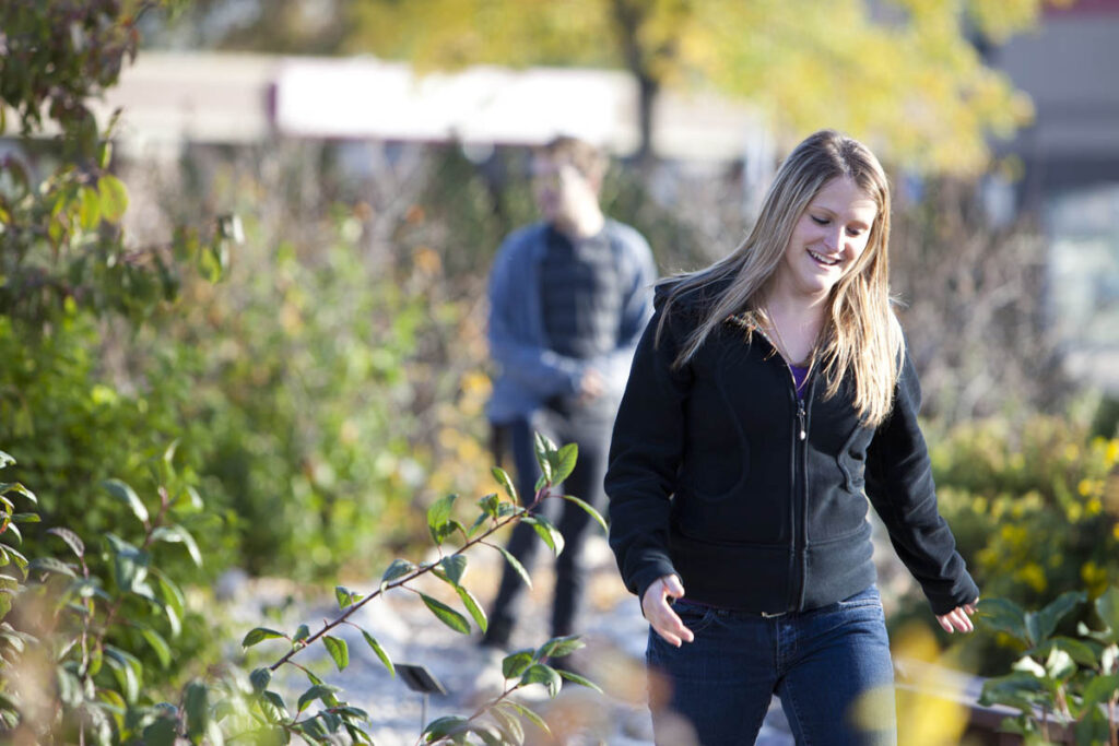 Woman walking through a garden