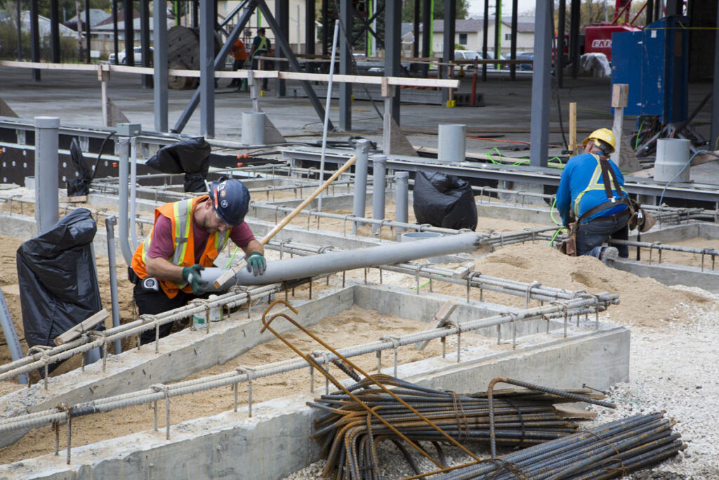 Construction workers building structure at a work site