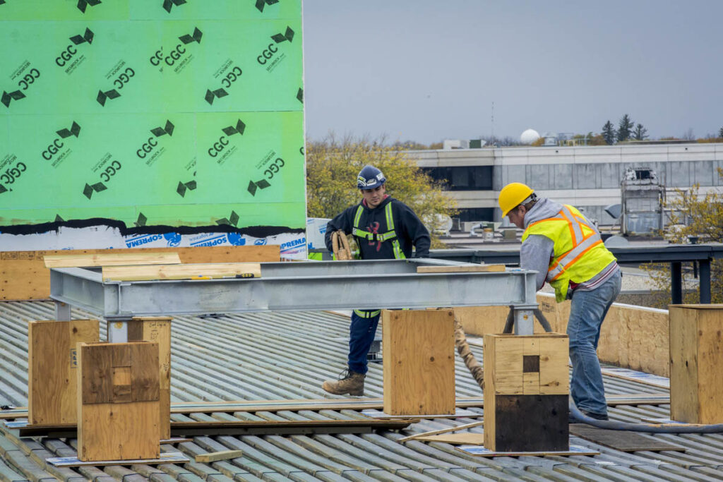 Construction workers building structure at a work site